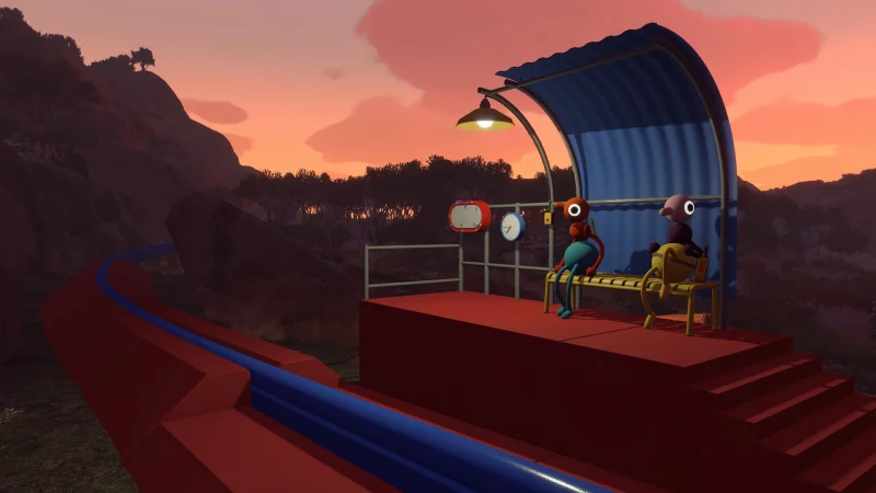 Two birds sit under a shelter on a red viewing platform at sunset in Big Walk