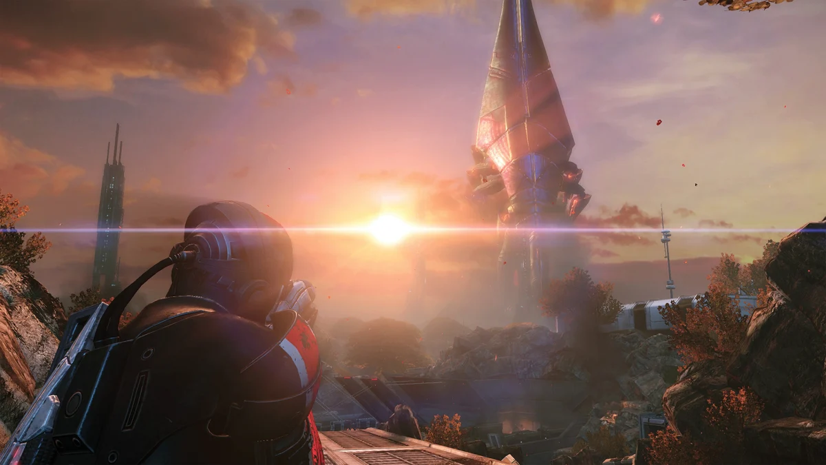 An N7 soldier looks out at a towering spire under a setting sun in Mass Effect Legendary Edition