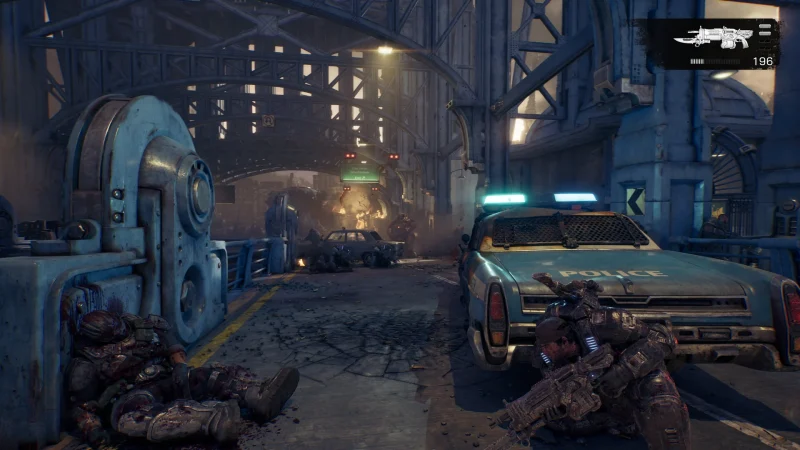 A ruined industrial street with a wrecked car in Gears of War: E-Day
