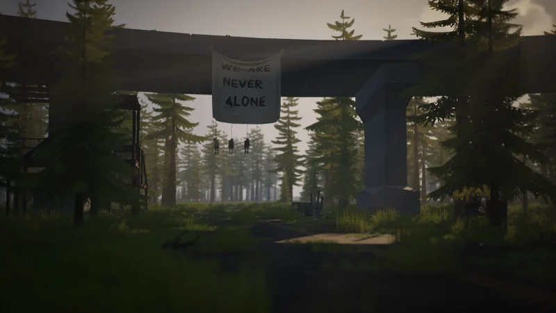 An overgrown highway bridge with a 'Never Be Alone' banner above a forest road