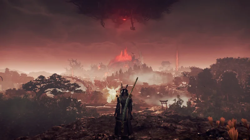 A samurai looks out over a burning valley under a red sky in Nioh 3