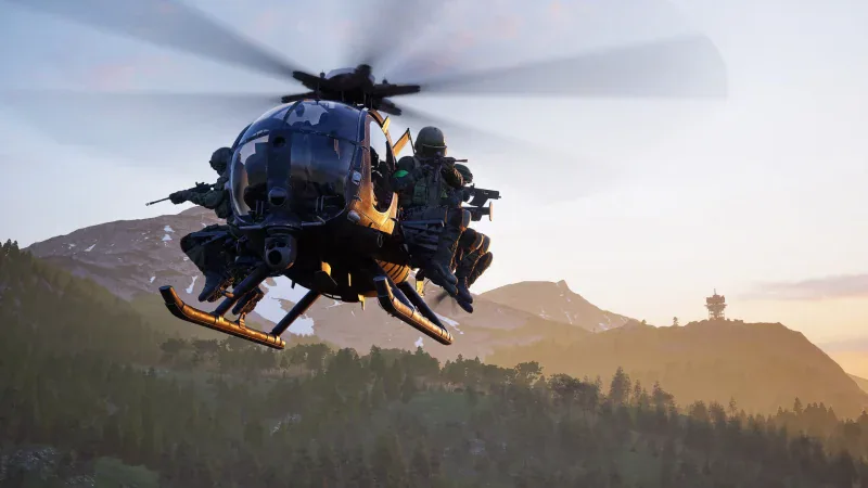 Soldiers ride on the side of a Little Bird helicopter over mountains at sunset in WARDOGS