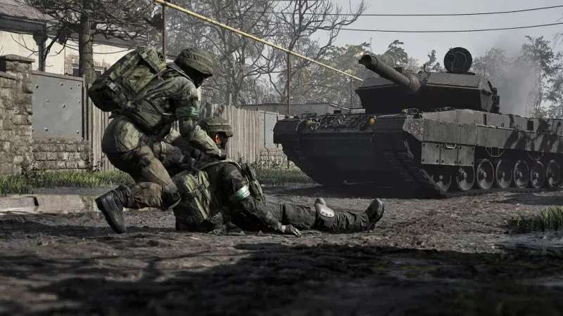 A soldier drags a wounded teammate to safety as a tank rolls past in WARDOGS